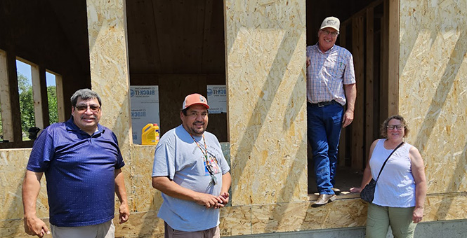 people in front of house construction